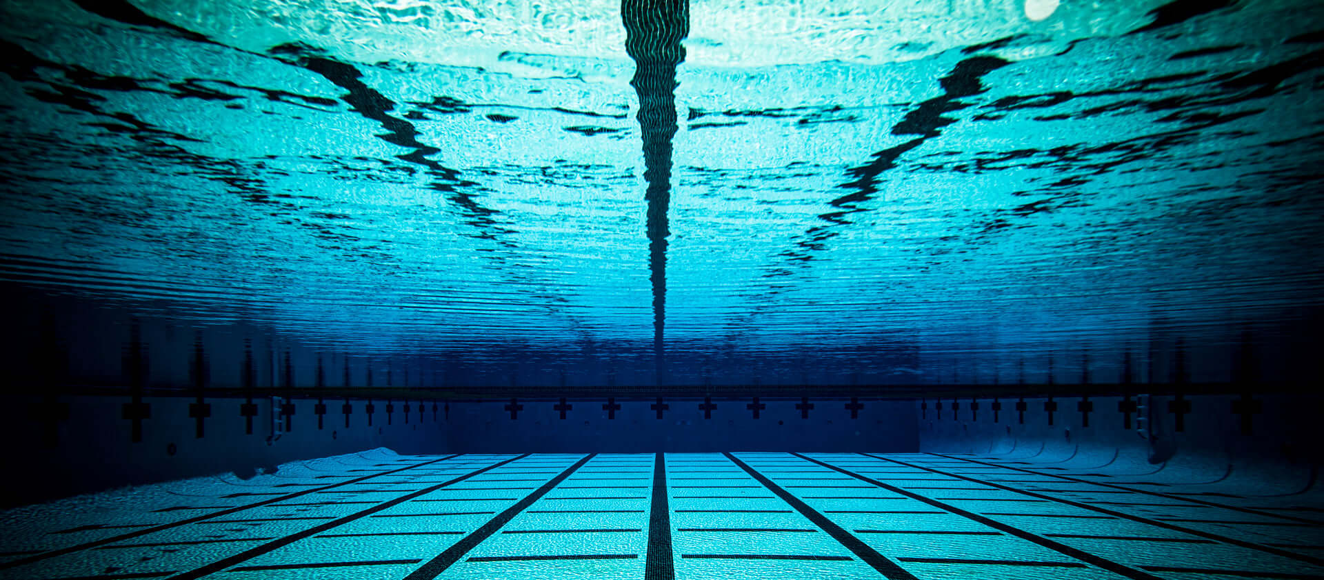 underwater image of pool located the h2o audio waterproof headphones homepage