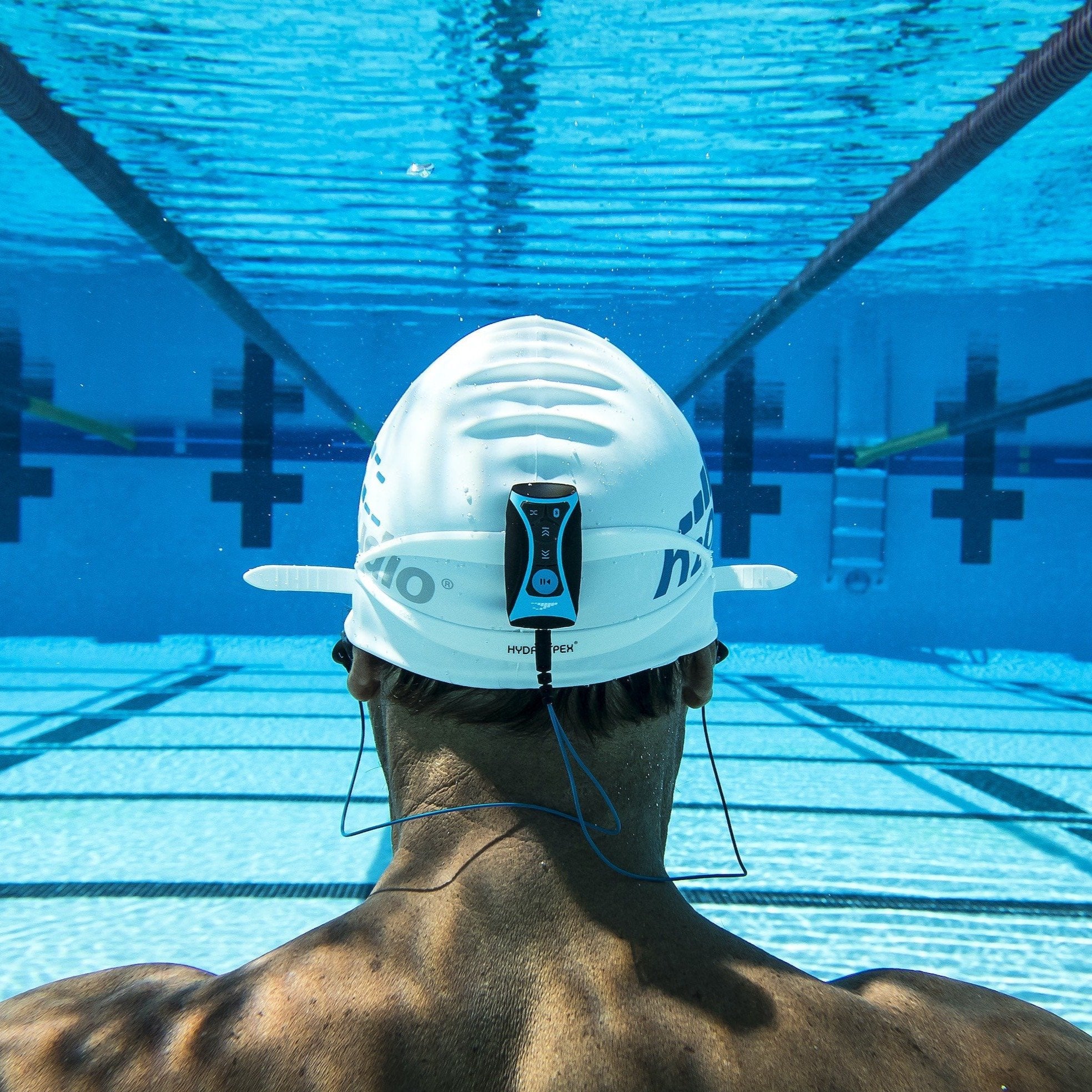 image of underwater mp3 player for swimming attached to the back of a swimmers head cap located on h2o audio waterproof headphones homepage