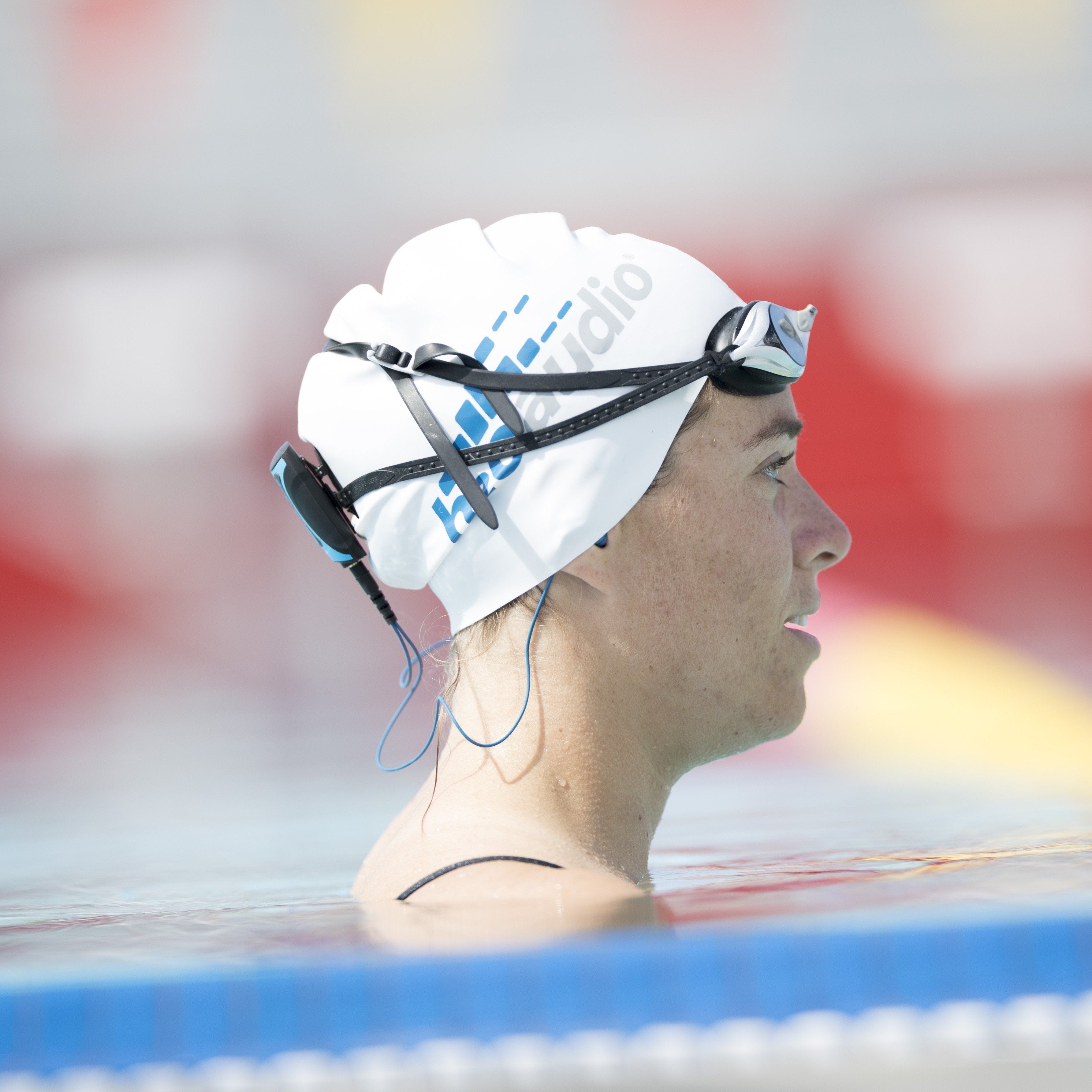 image of a swim athlete in water using waterproof headphones and mp3 player located on h2o audio waterproof headphones homepage