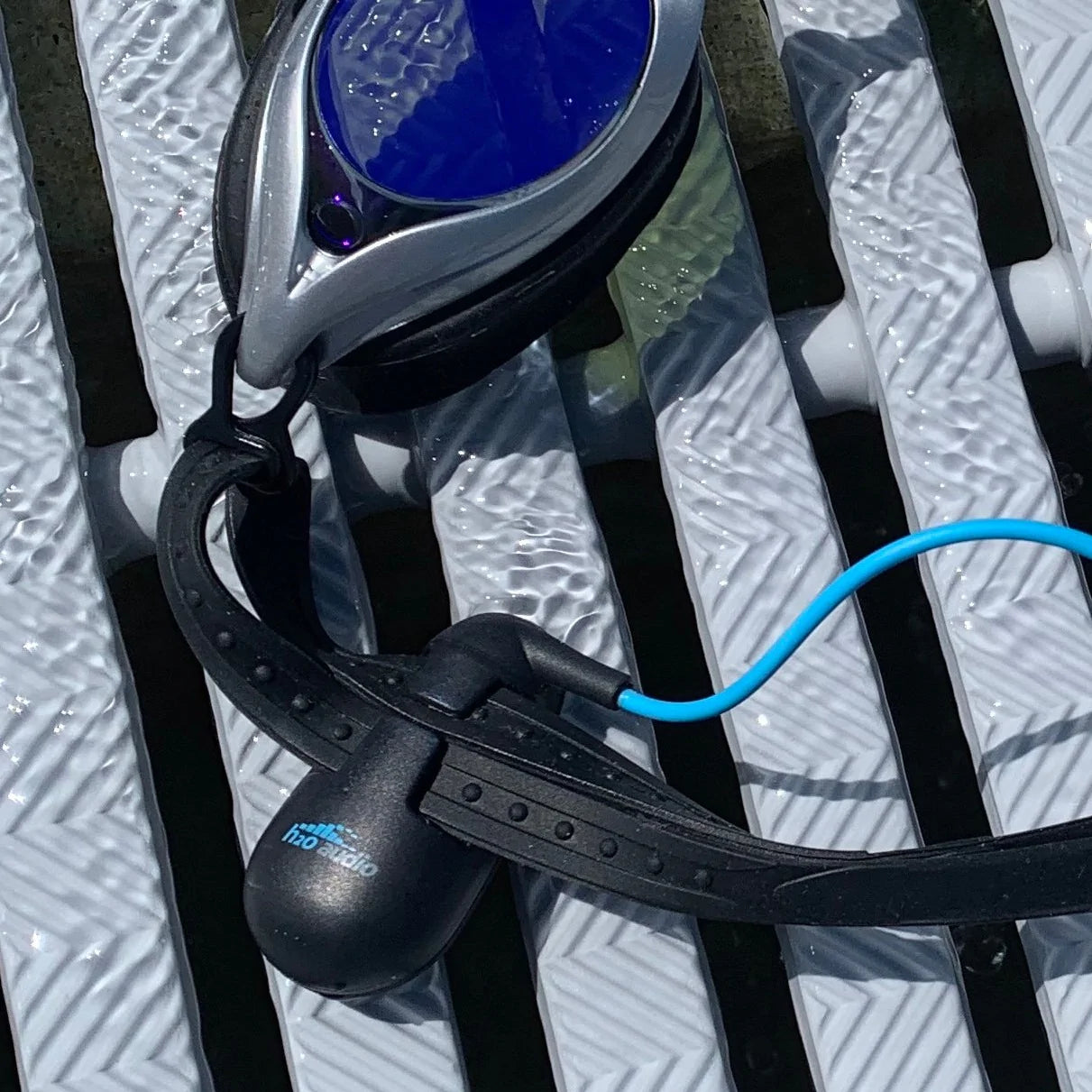 image of stream 3 pro with playlist+ attached to a pair of swimming goggles located on h2o audio waterproof headphones homepage
